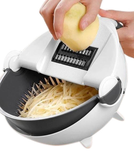 Vegetable cutter with attached rotating drain basket and slicing blades