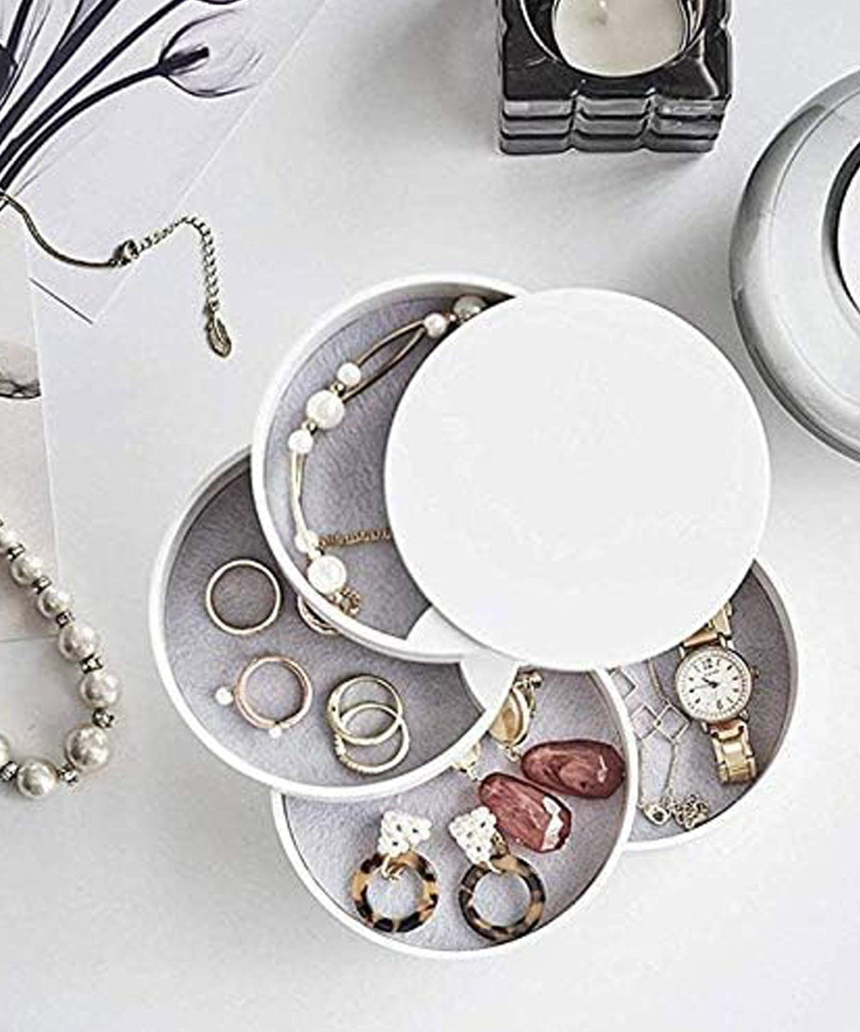 Four-layer rotating jewelry box with mirror, ideal for storing earrings and accessories.