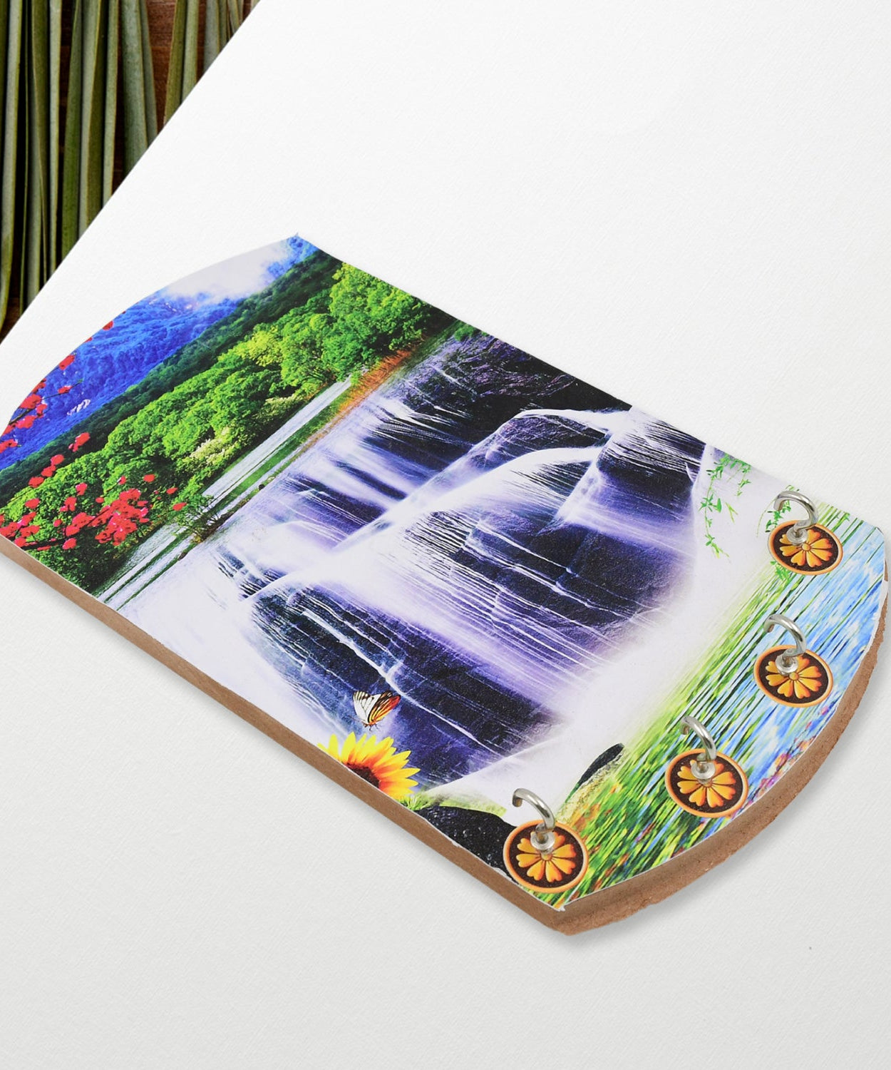 Decorative wooden wall hanging with vertical scenery and hooks.