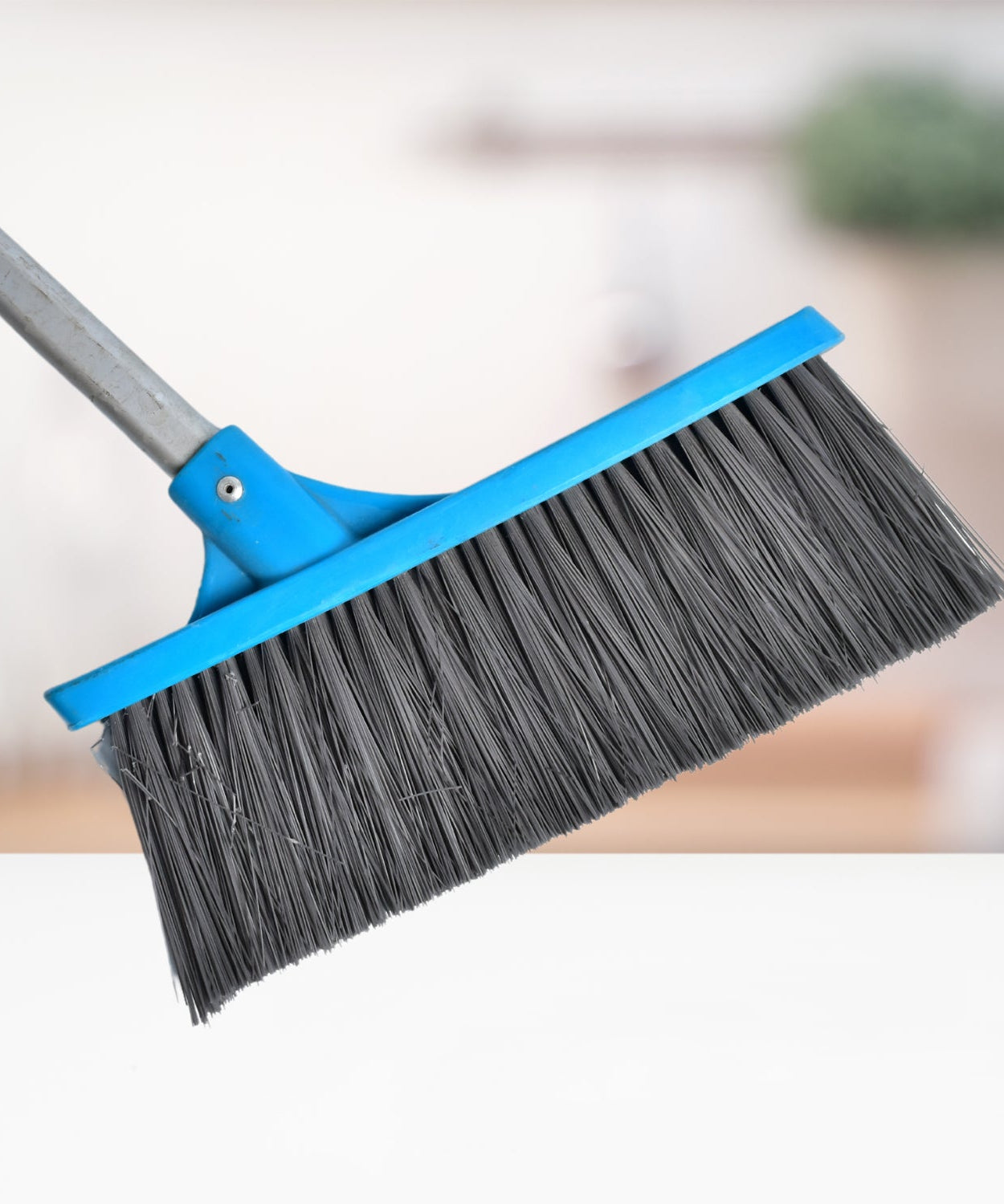 Stiff-bristle floor scrub brush with long handle, suitable for bathroom and garage use.