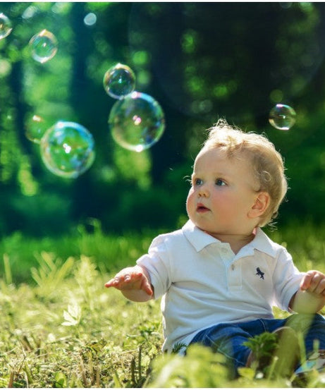 Bubble gun liquid refill bottle with blue cap on a white background