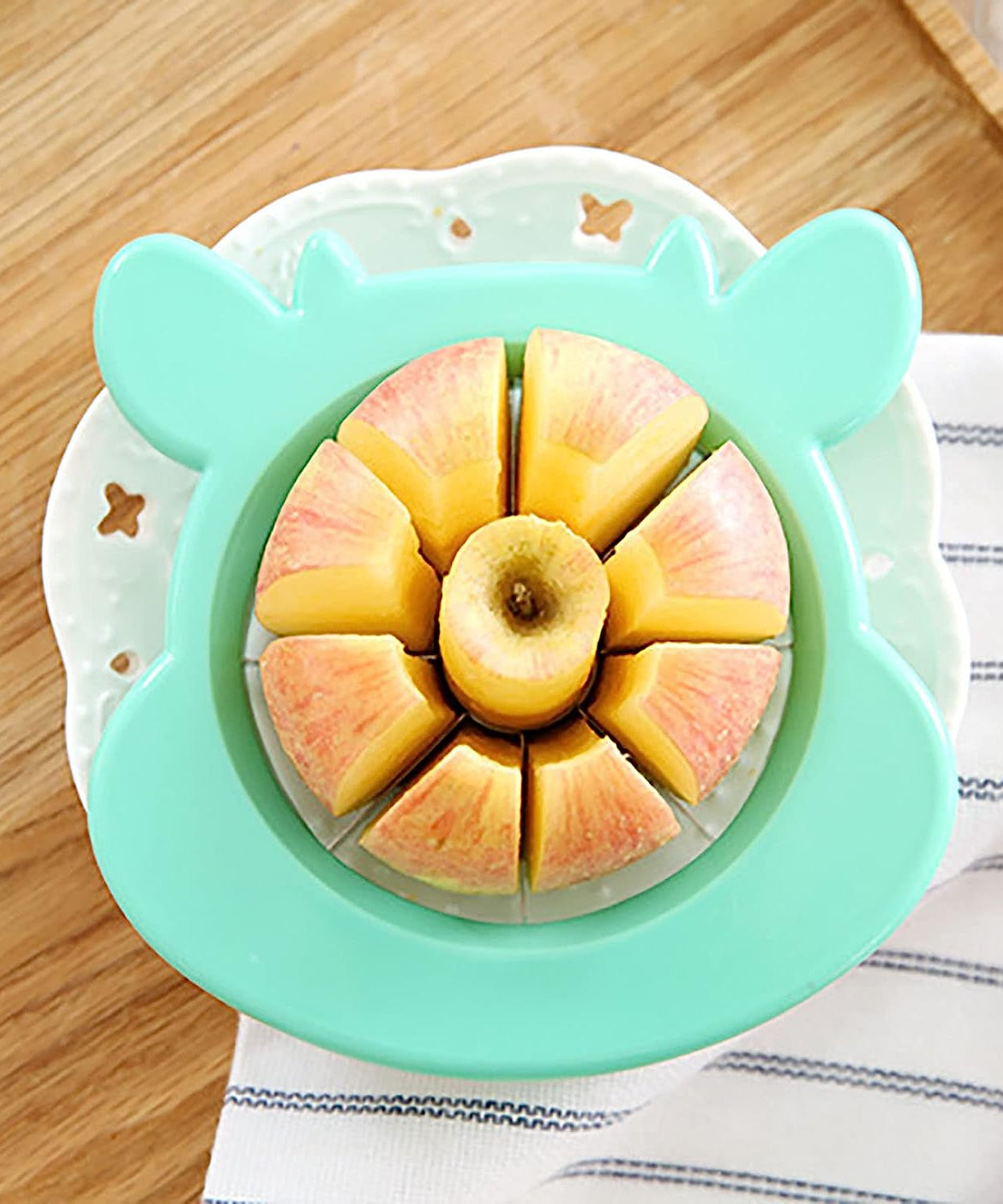 Apple cutter and corer tool, made of stainless steel, designed for slicing and peeling.