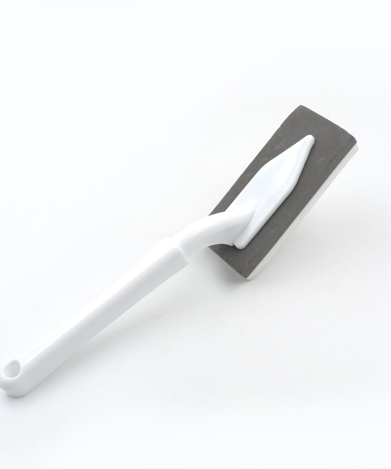Versatile kitchen and bathroom cleaning brush with triangle design