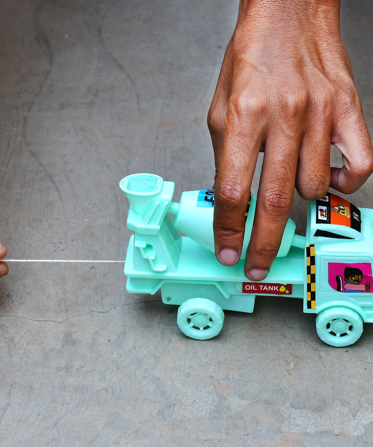 Friction-powered cement mixer toy