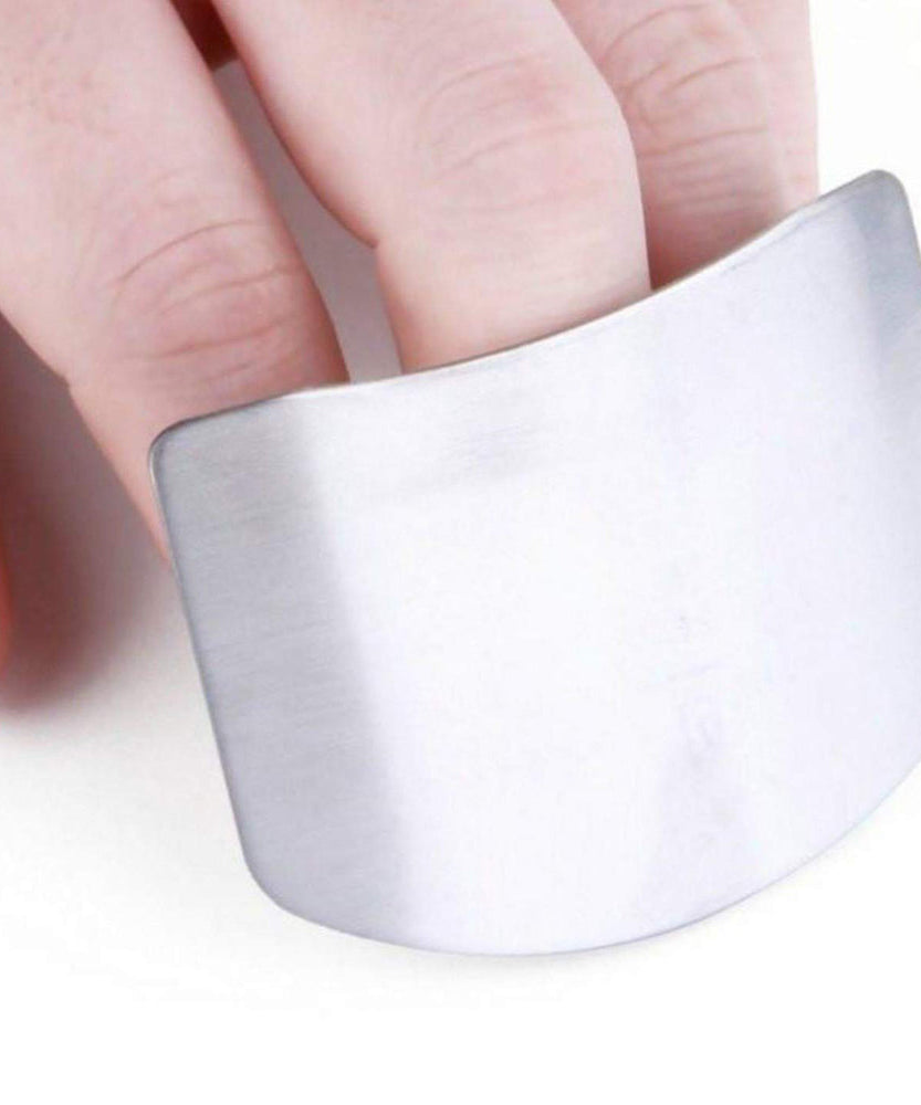 Stainless steel finger guard for safe cutting in kitchen.