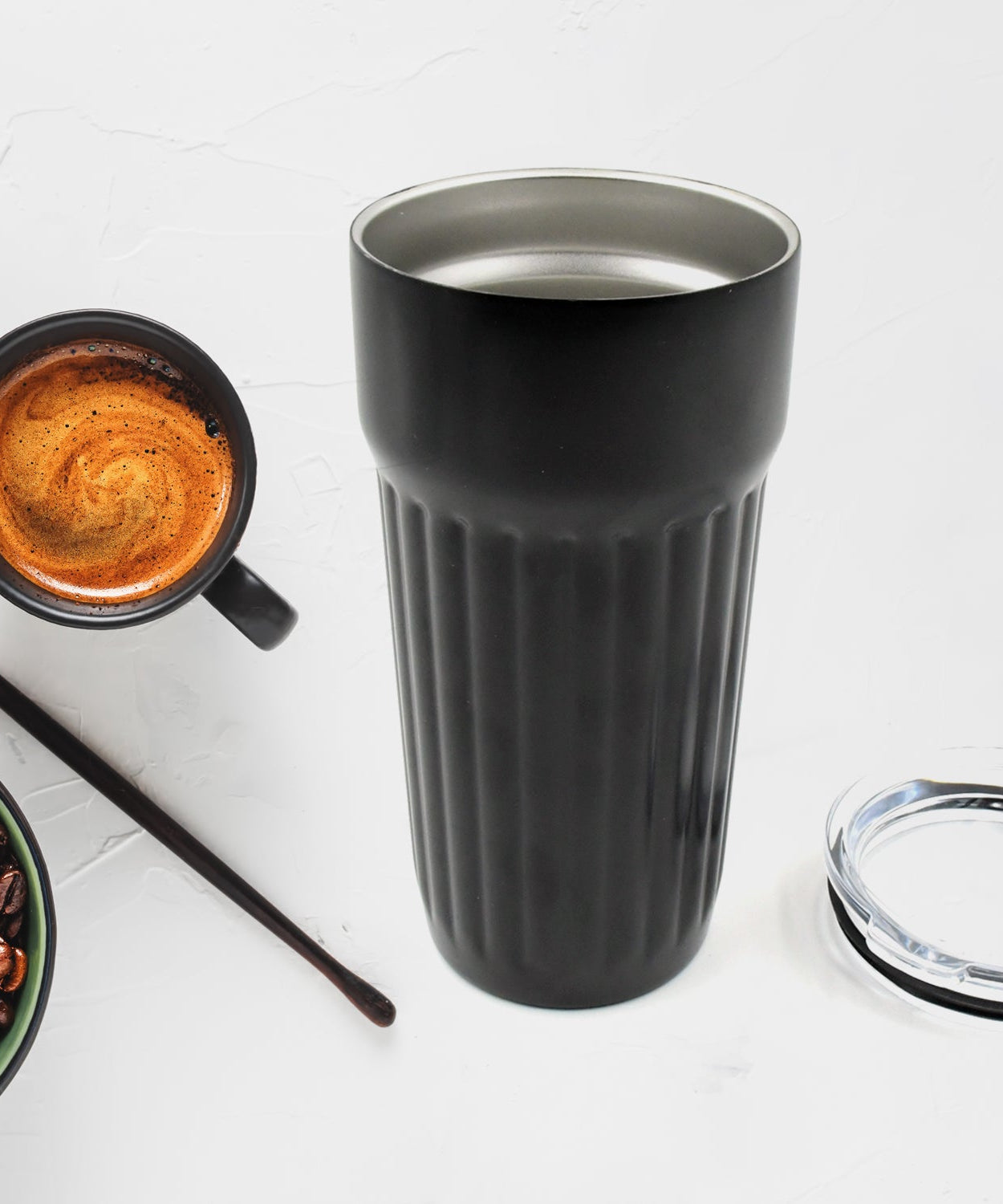 Stainless steel travel mug with vacuum insulation for coffee.