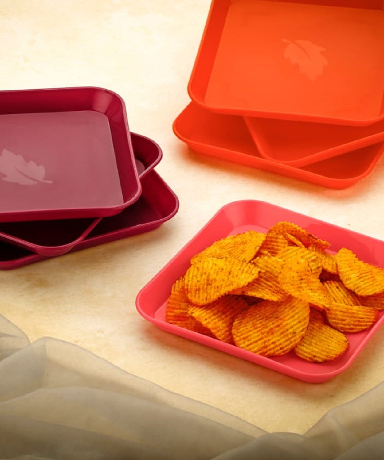 Colorful square plates on a table.