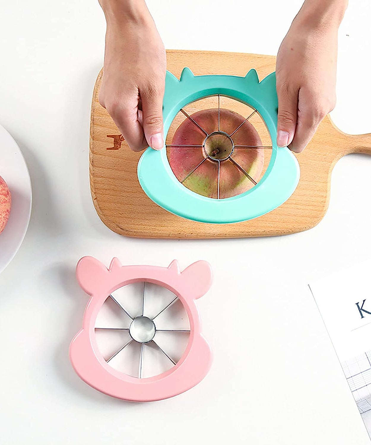 Apple corer and slicer tool, with stainless steel and plastic components for easy use.