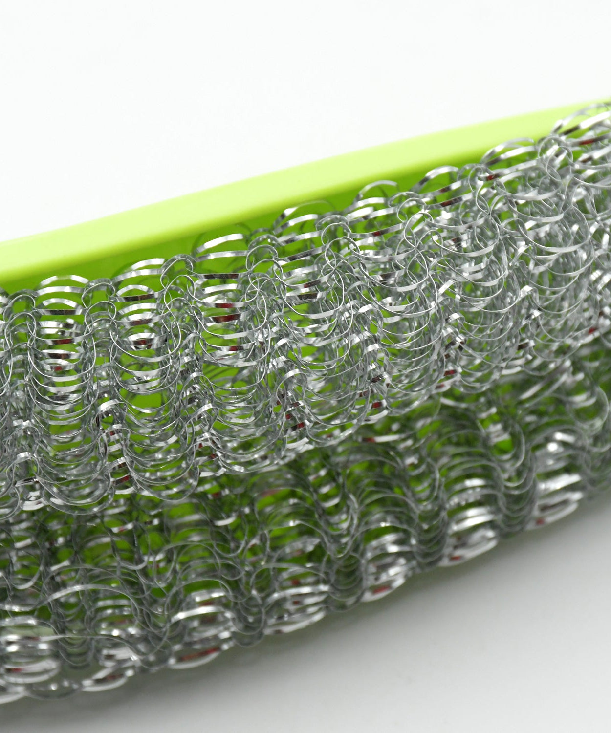 Close-up of kitchen washing brush showing wire bristles and bendable handle.