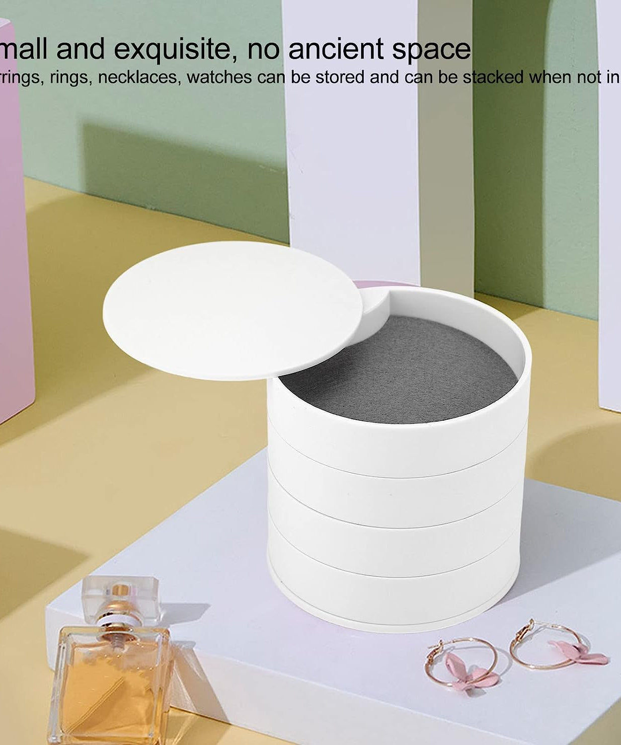 Rotating jewelry box with four layers and mirror, designed for organizing accessories.