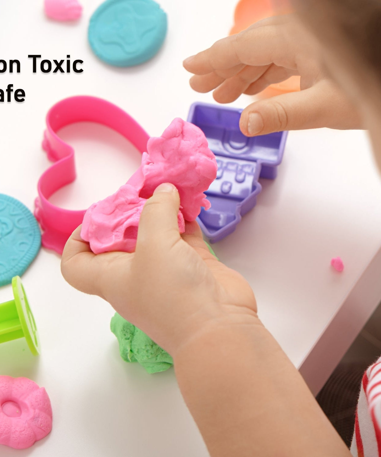 Kinetic sand in a container with toy molds.