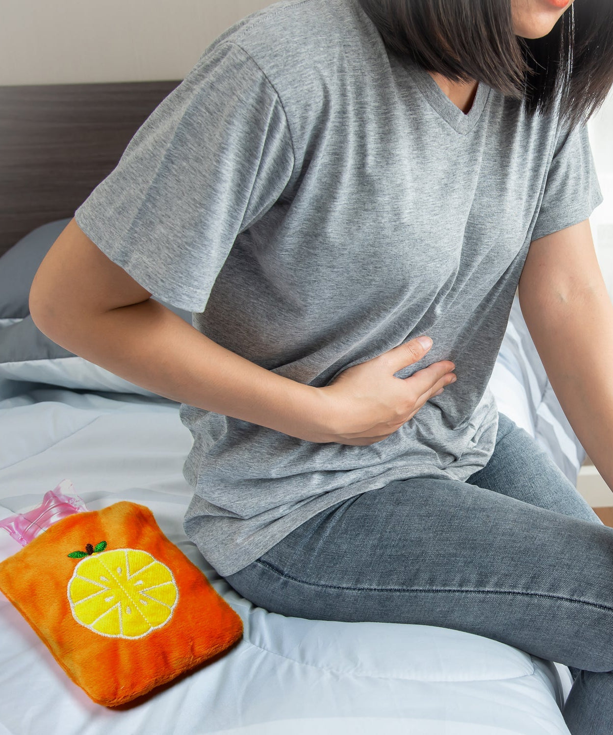 Small orange hot water bag for hand and feet warmth