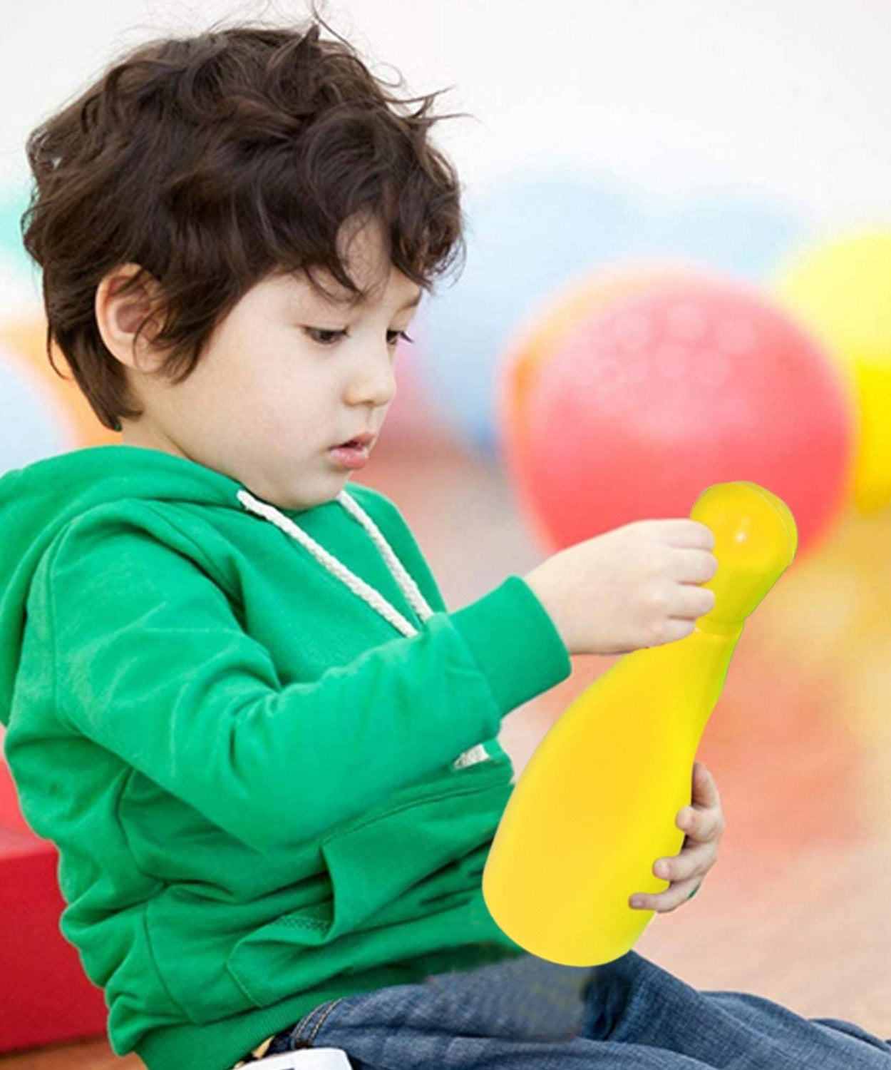 Kids enjoying bowling game set with colorful pins
