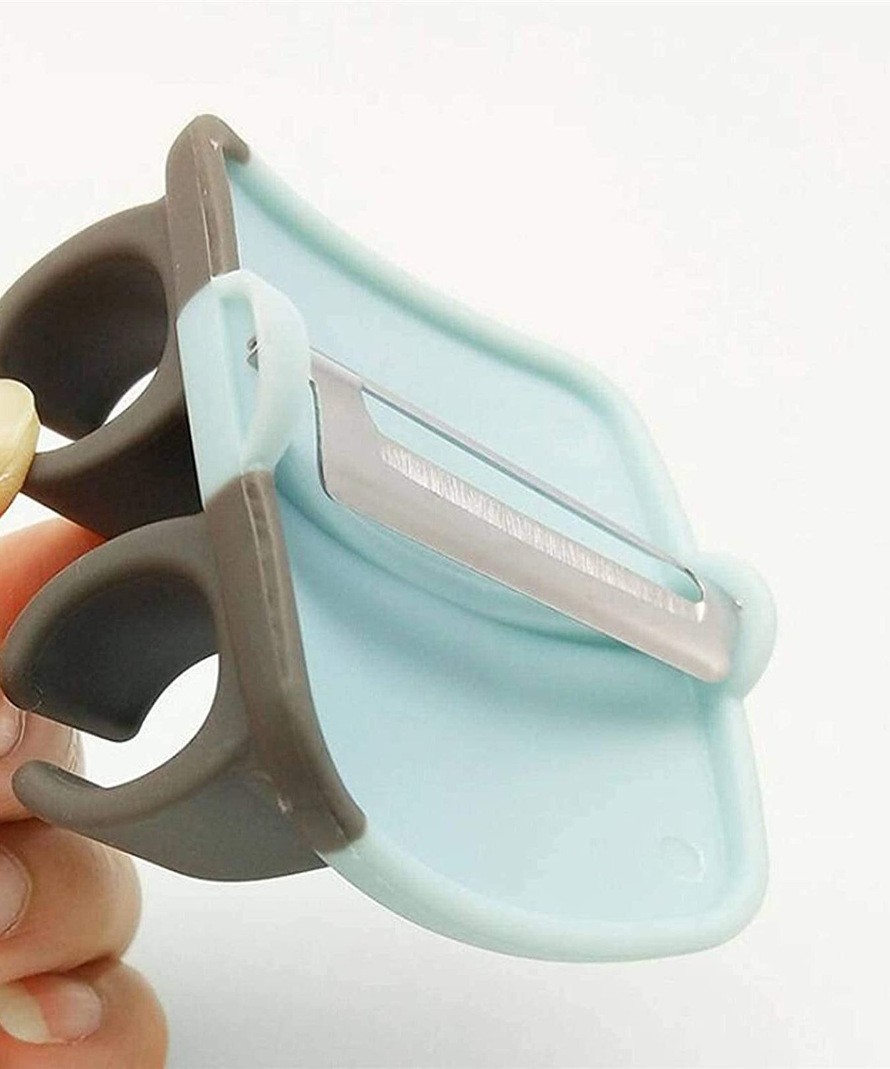 Hand palm vegetable peeler with rubber grip.