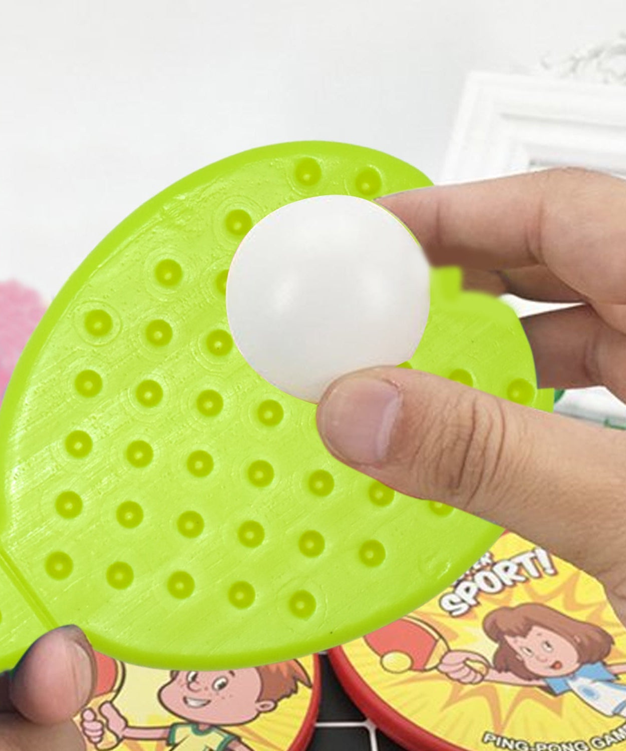 Different views of kids’ table tennis racquet and ball set