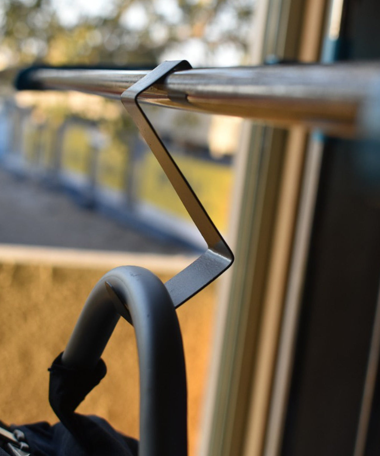 Z shape door hook in a home setting with fabric items.