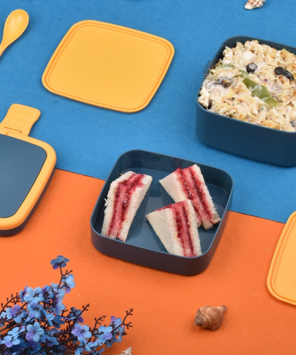 Blue lunch box with handle and spoon for meals