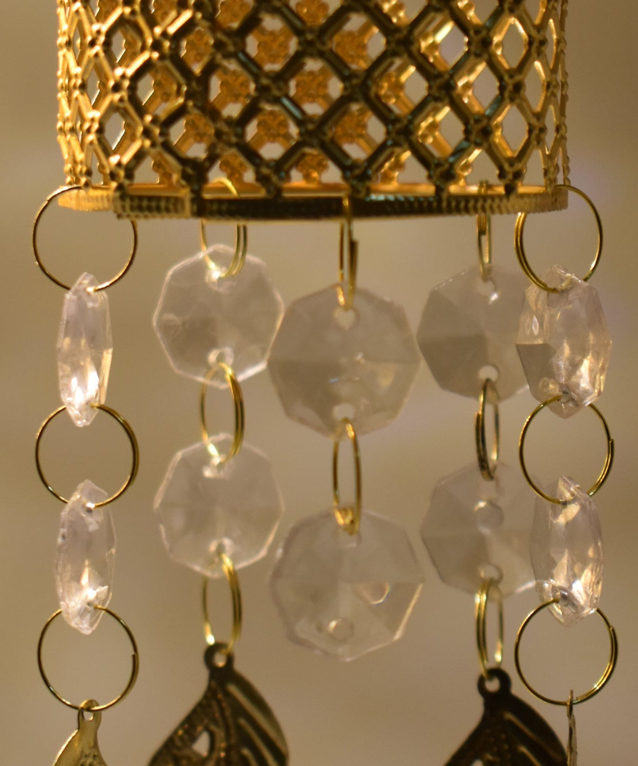 Golden jhoomer with detailed design.