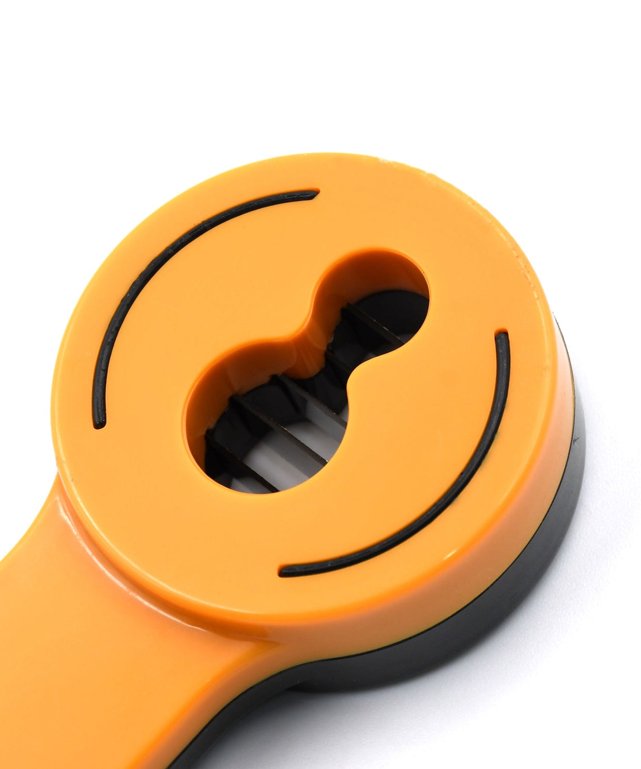 Convenient green kitchen cutter for slicing and peeling beans, making cooking easier.