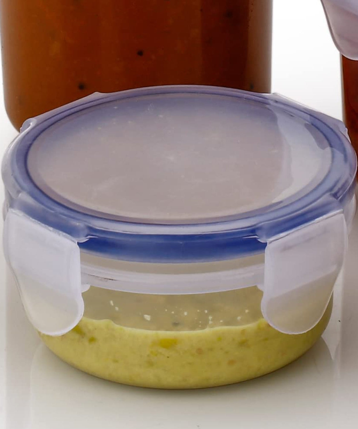 Transparent round food storage container with secure lid and airtight seal.