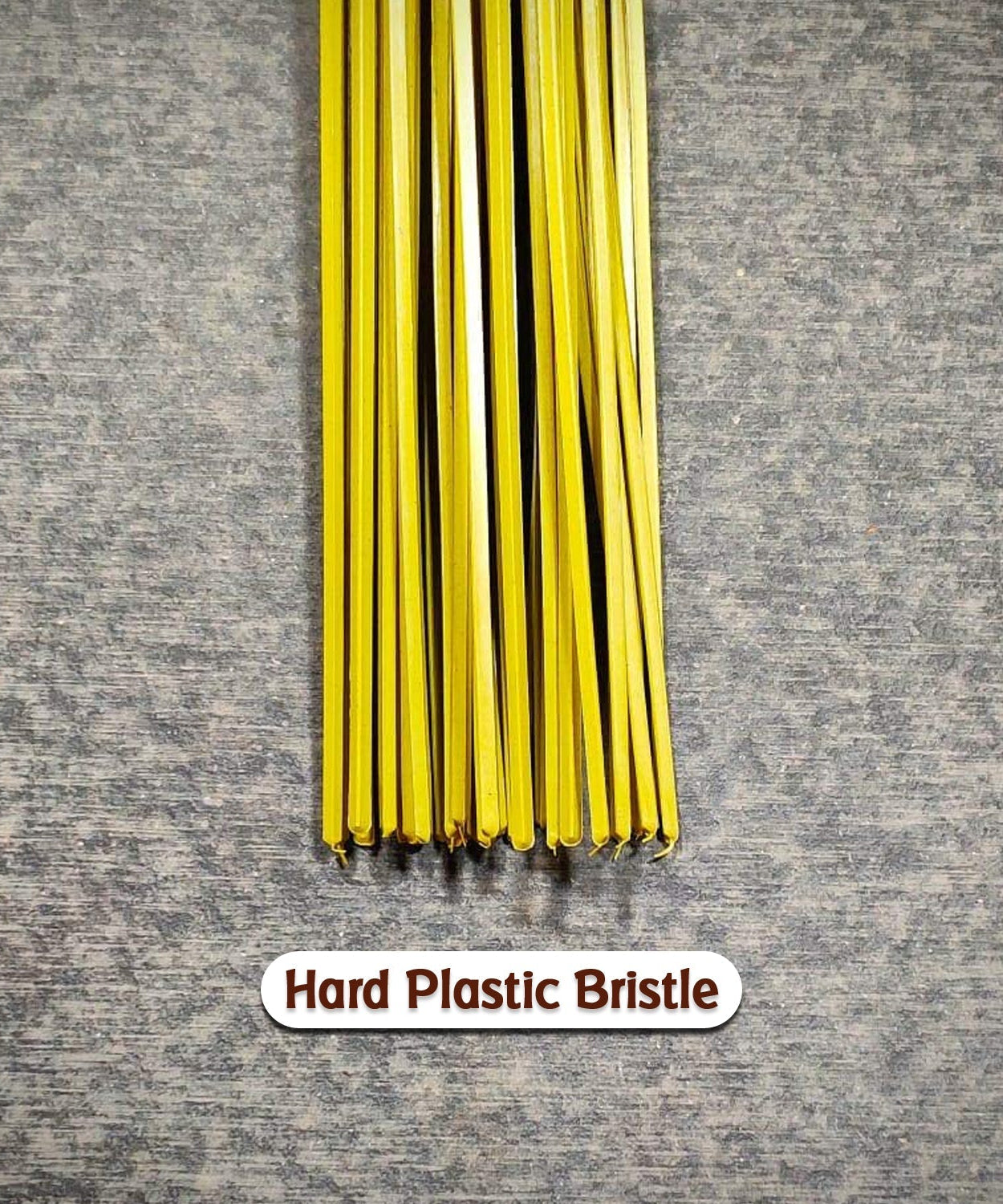 Hard bristle broom with plastic handle, close-up of bristles