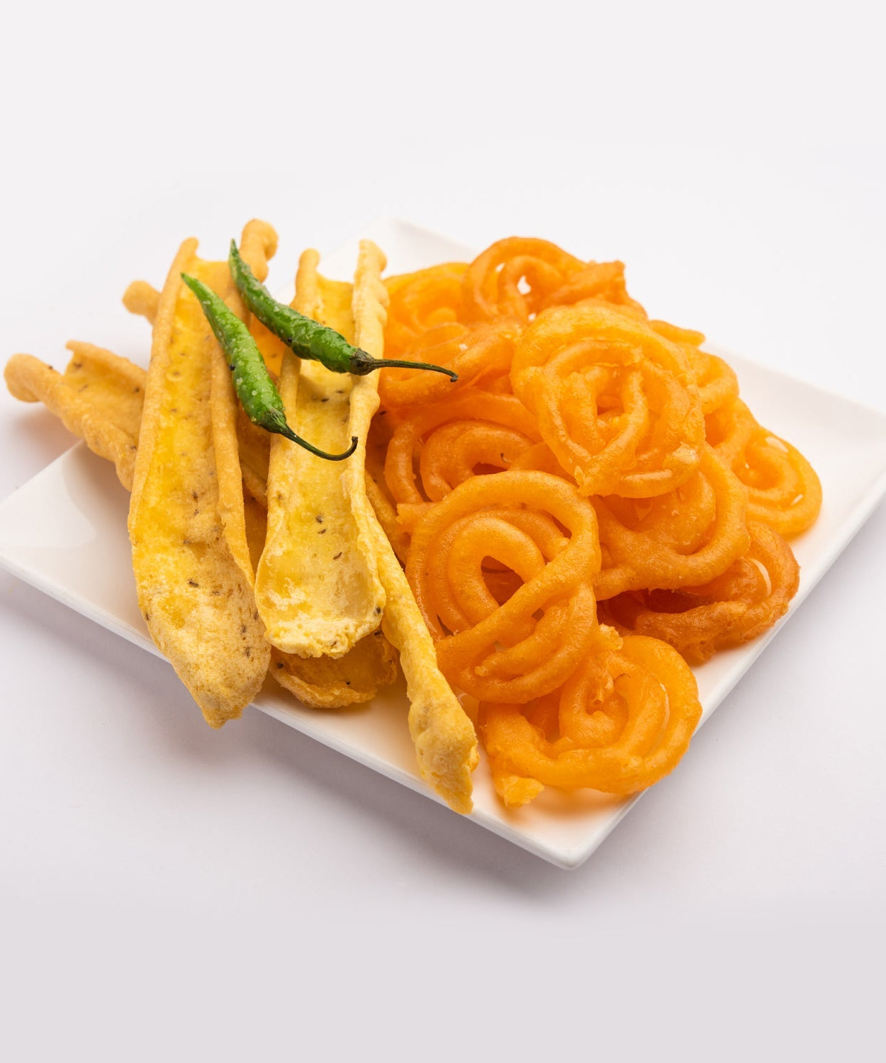 Stack of square plastic plates in different colors.