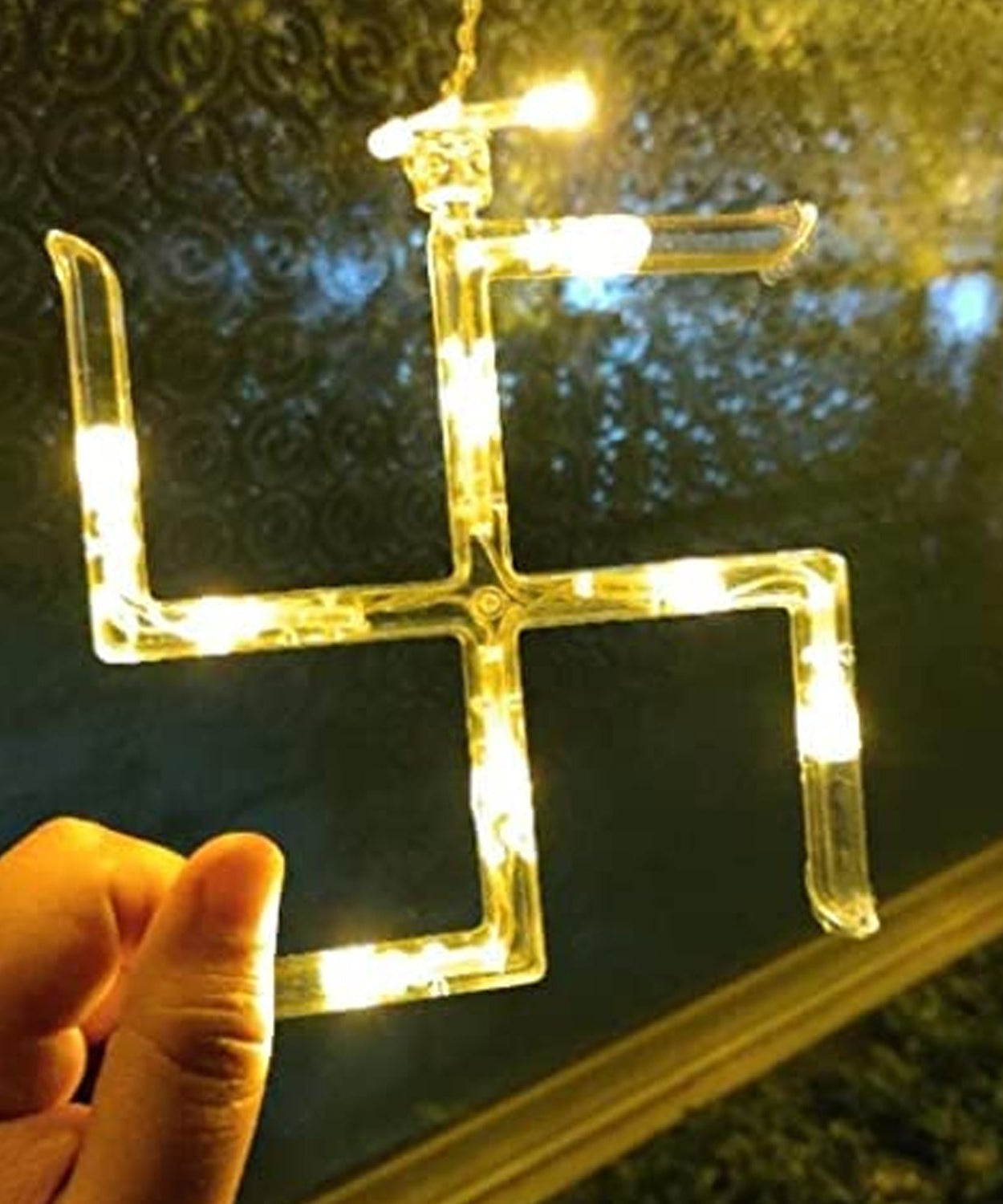 Detailed view of string lights with hanging props for festive decor.