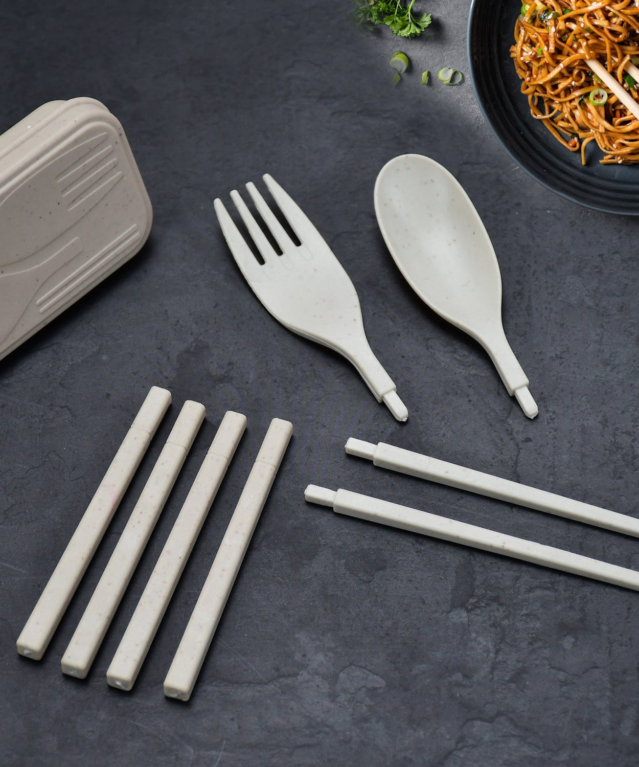 Portable travel cutlery set with spoon, fork, and chopsticks.