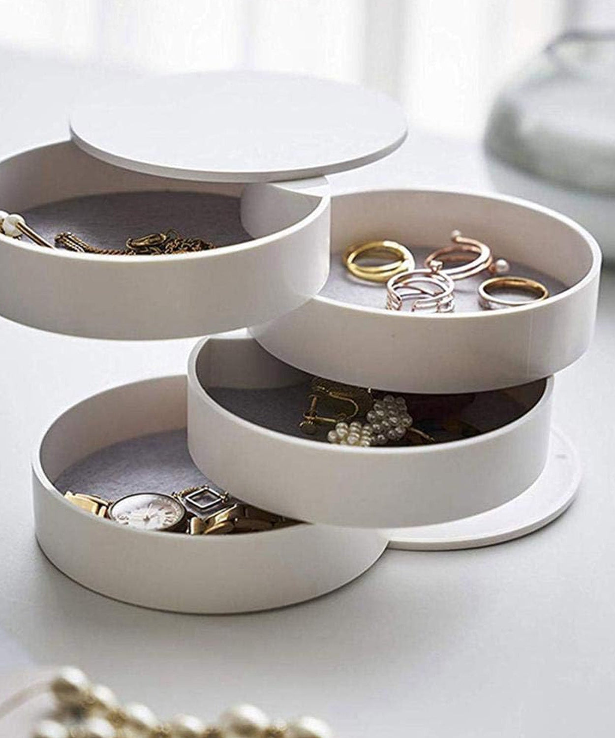 360-degree rotating jewelry box with mirror and multiple storage layers.