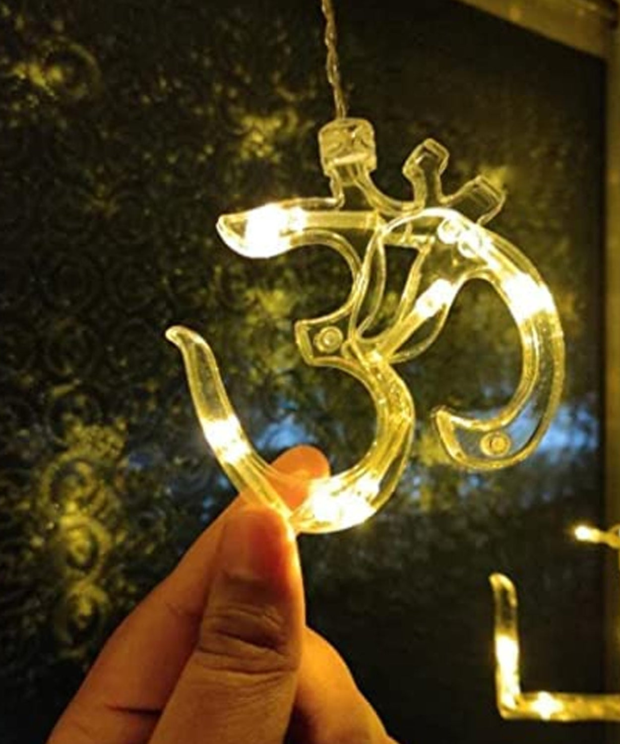 Swastik Om curtain lights highlighting the LED bulbs and hanging props.