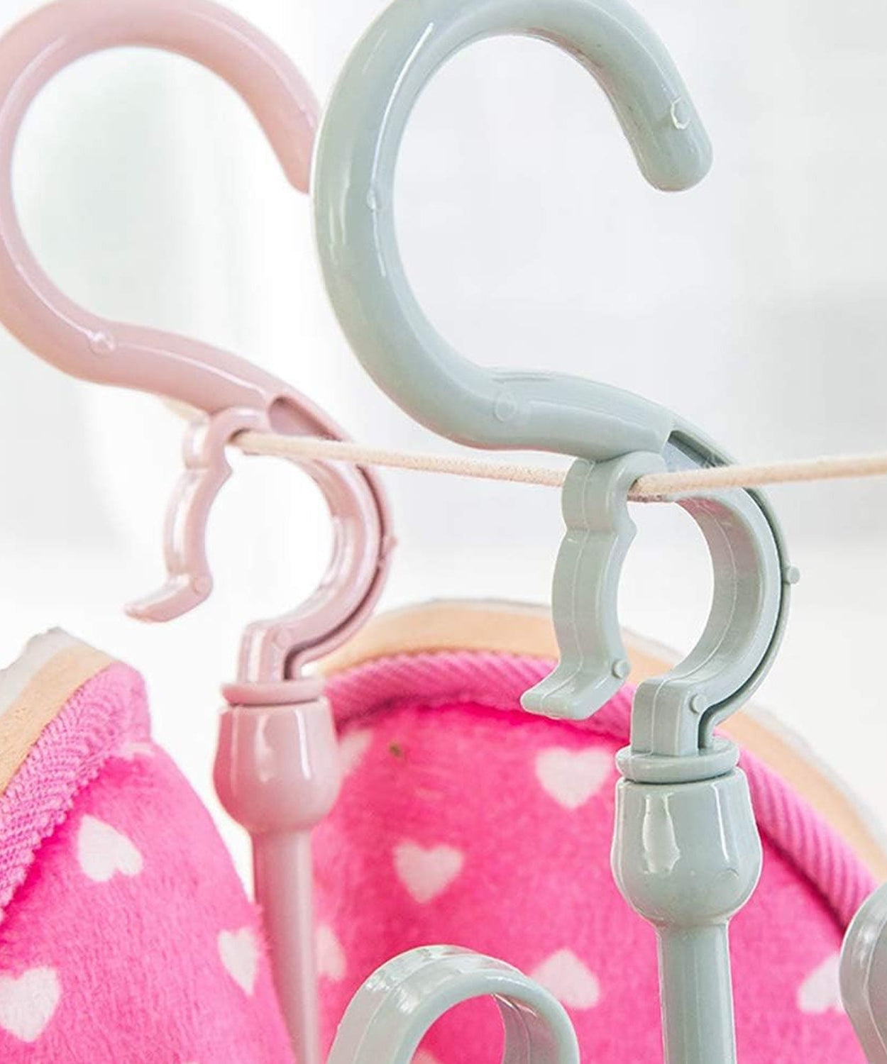 Adjustable and rotatable shoe hanger for effective drying in closet or balcony.