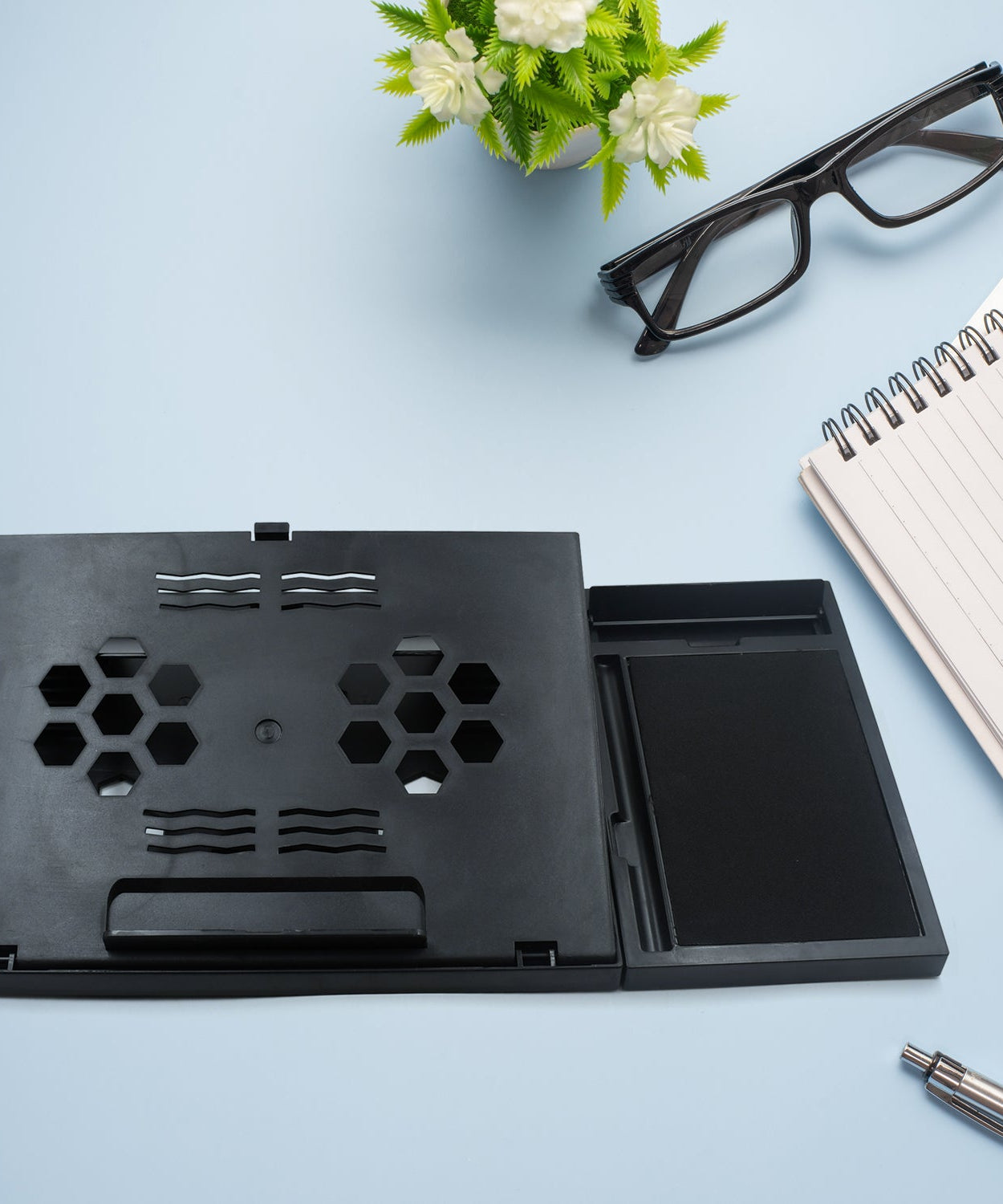 Portable foldable laptop stand with phone holder, compatible with MacBook and tablets.