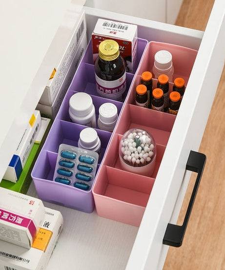 Clear bead storage tray with several compartments, showing multicolored sections.