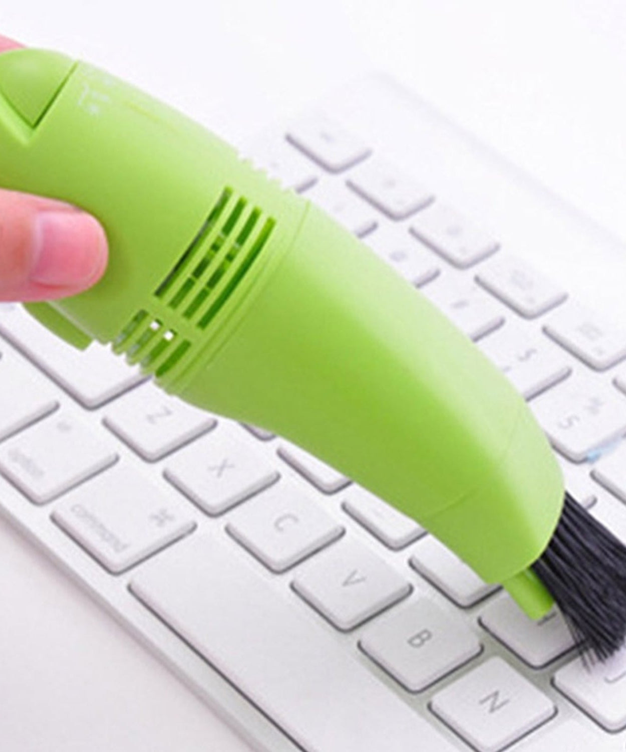Compact and portable mini vacuum cleaner for targeted cleaning of electronic devices.