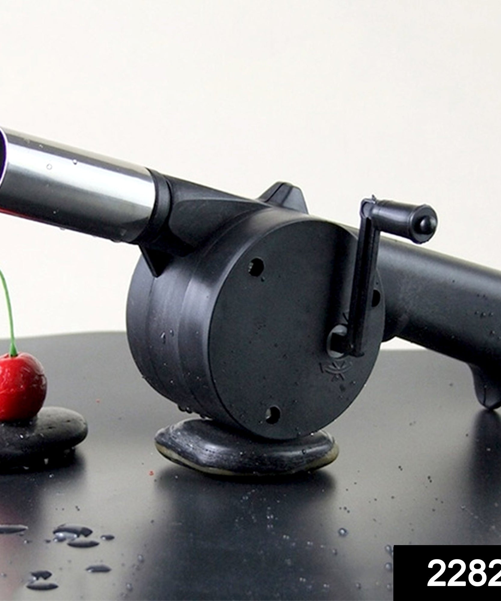 Air blower fan for charcoal BBQs with manual crank.