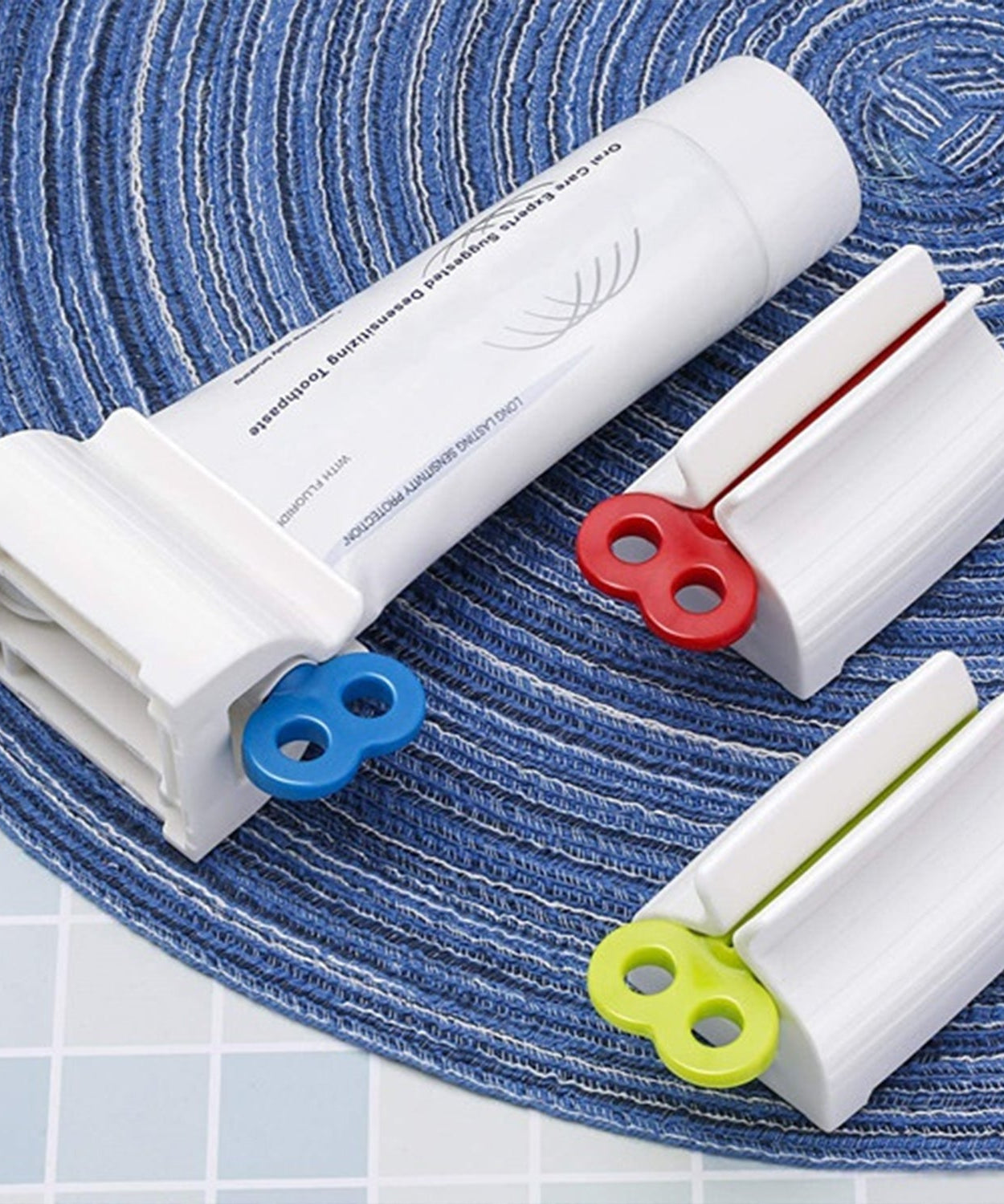Stand for toothpaste tubes with built-in squeezer