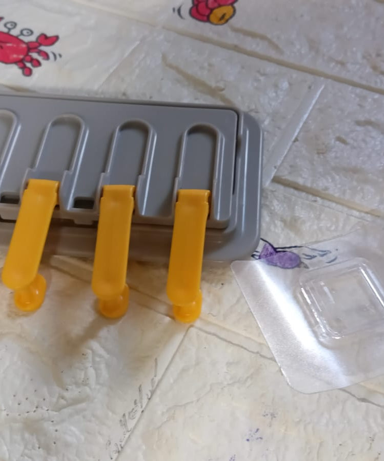 Multi-purpose wall hook for towels and mobile holder, foldable design