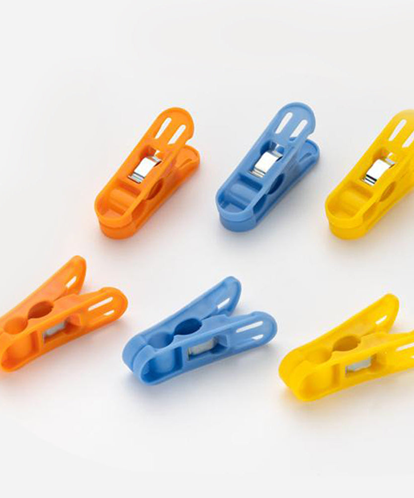 Durable non-slip plastic clips for cloth drying in bright colors.