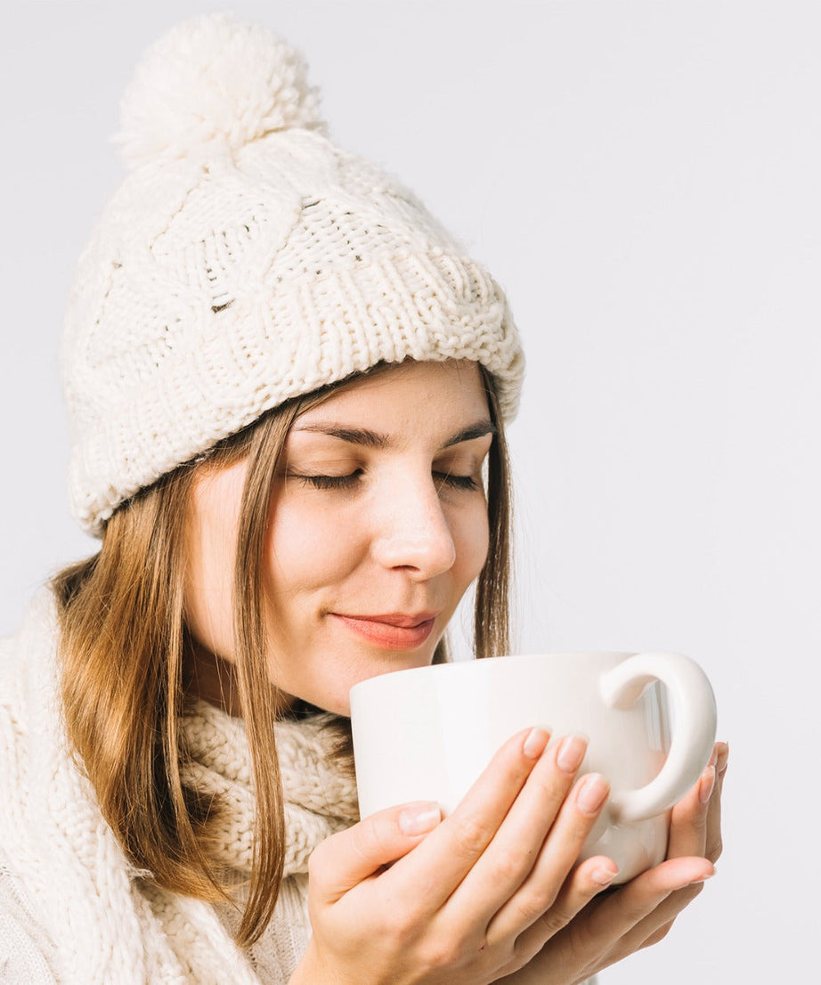 Warm winter cap with black knitted exterior and fur lining