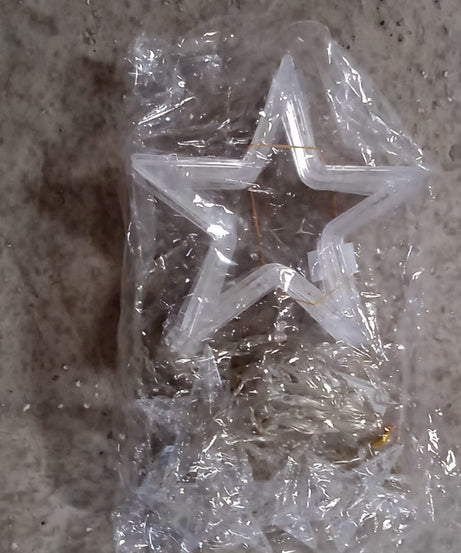 Window curtain string lights with star-shaped decorations