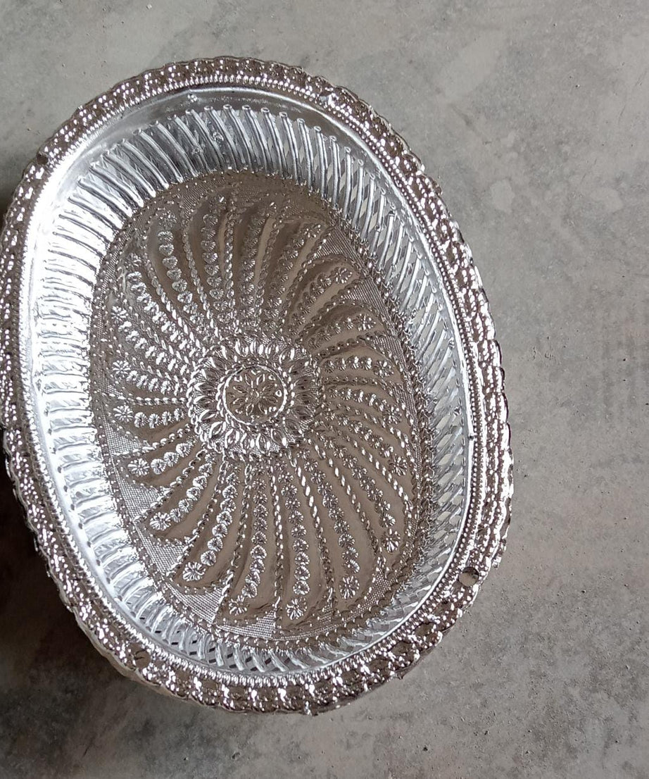 Multipurpose oval silver tray with a royal pattern for various uses.