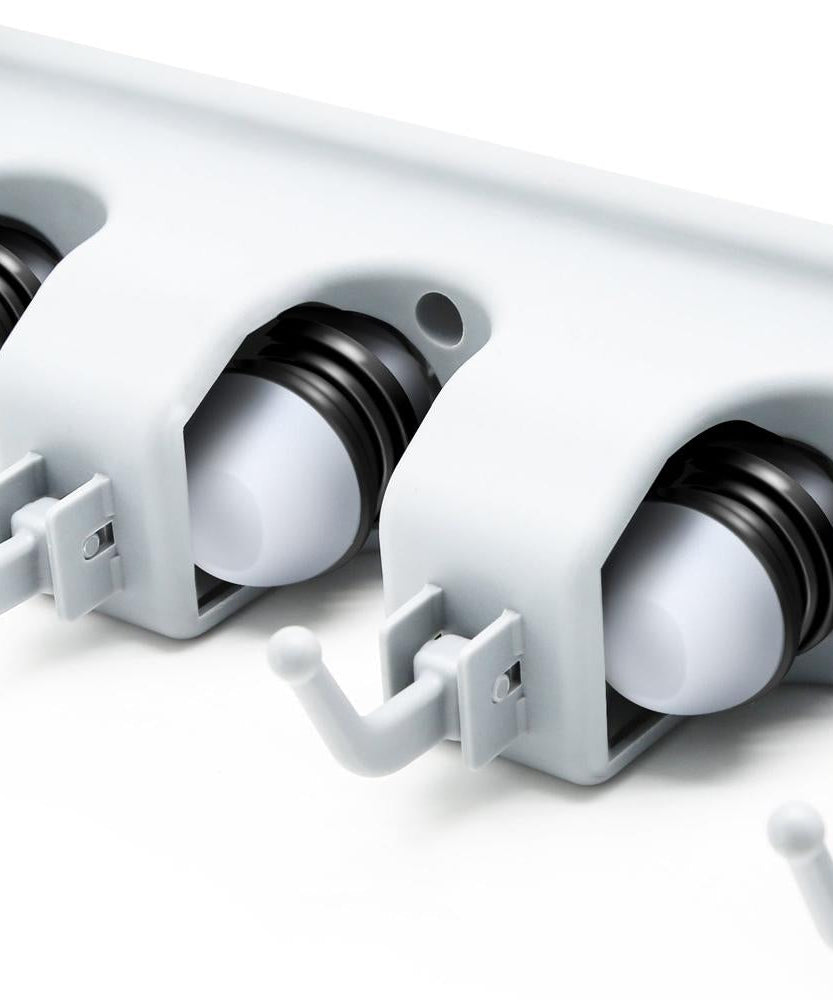 Multipurpose wall-mounted holder for mops and brooms.