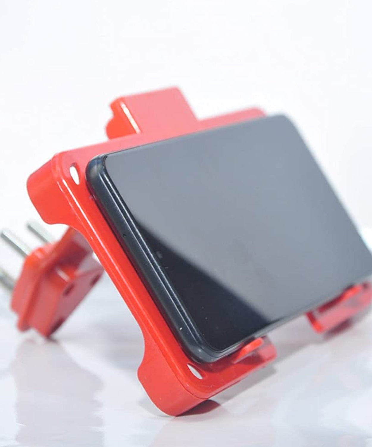 Wall-mounted mobile charging holder in red.