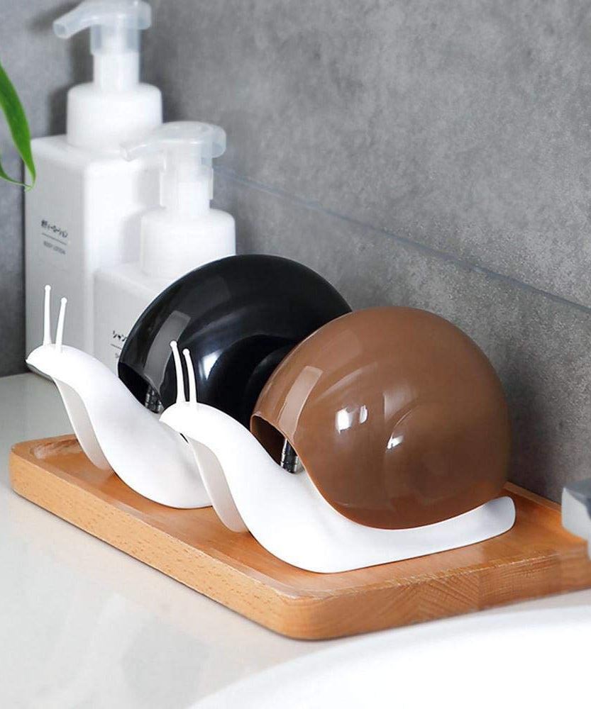 Unique snail-shaped soap dispenser for convenient liquid soap access.