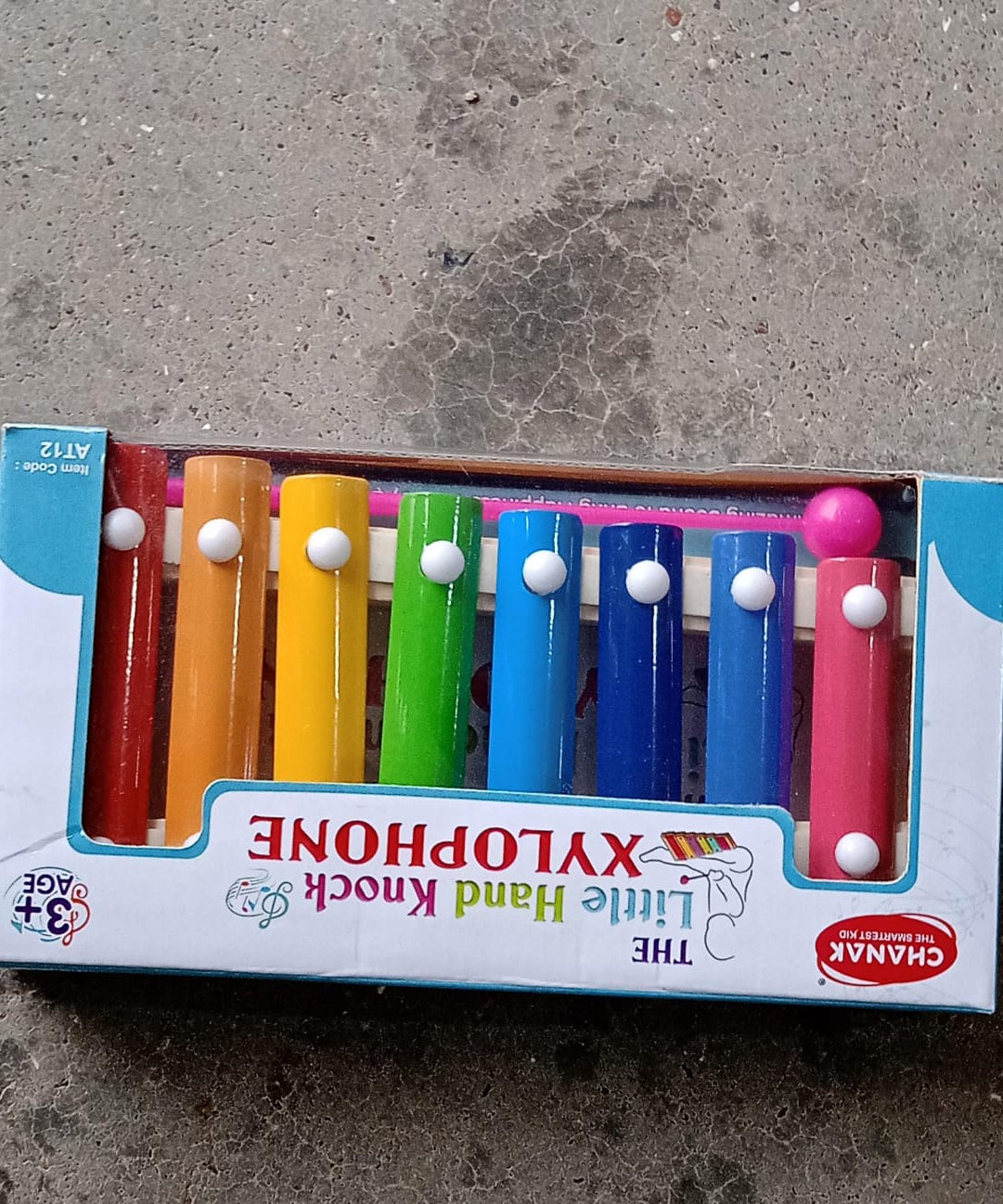 Xylophone with vibrant colored bars and wooden frame, displayed with mallet