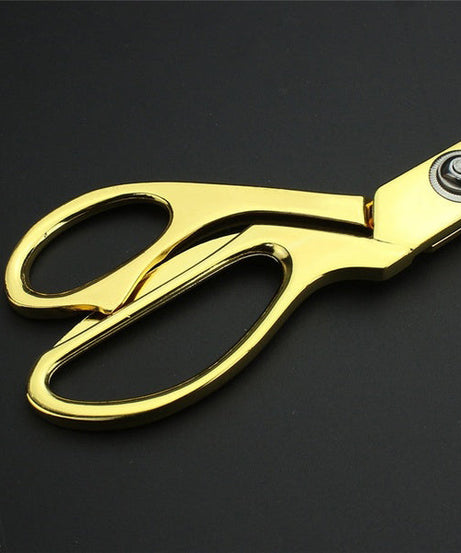 Durable cloth cutting scissors with gold-plated finish.