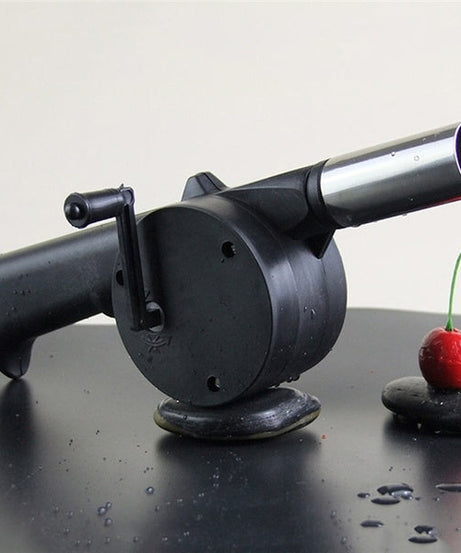 Portable hand crank air blower for charcoal grilling and BBQs.