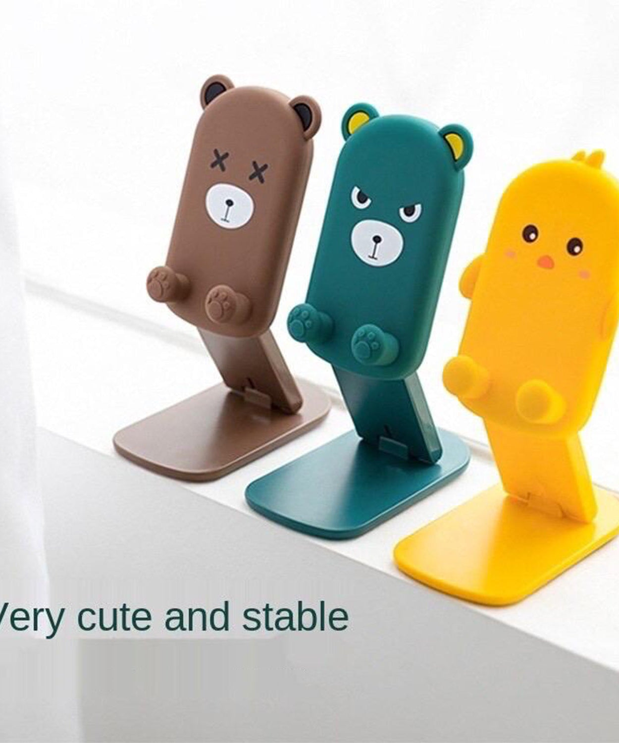 Compact and foldable mobile stand with a playful cartoon design, demonstrating its portability and function