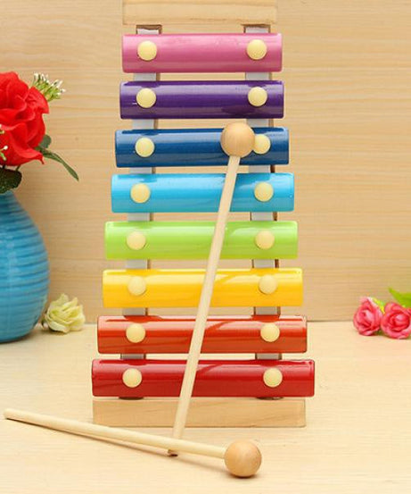 Multicolored wooden xylophone with mallet displayed on a surface