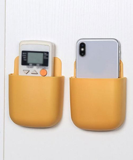 Wall mounted multicolour storage box for remotes.